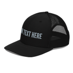 Angled view of a custom Richardson 112 trucker hat with embroidered personalized text