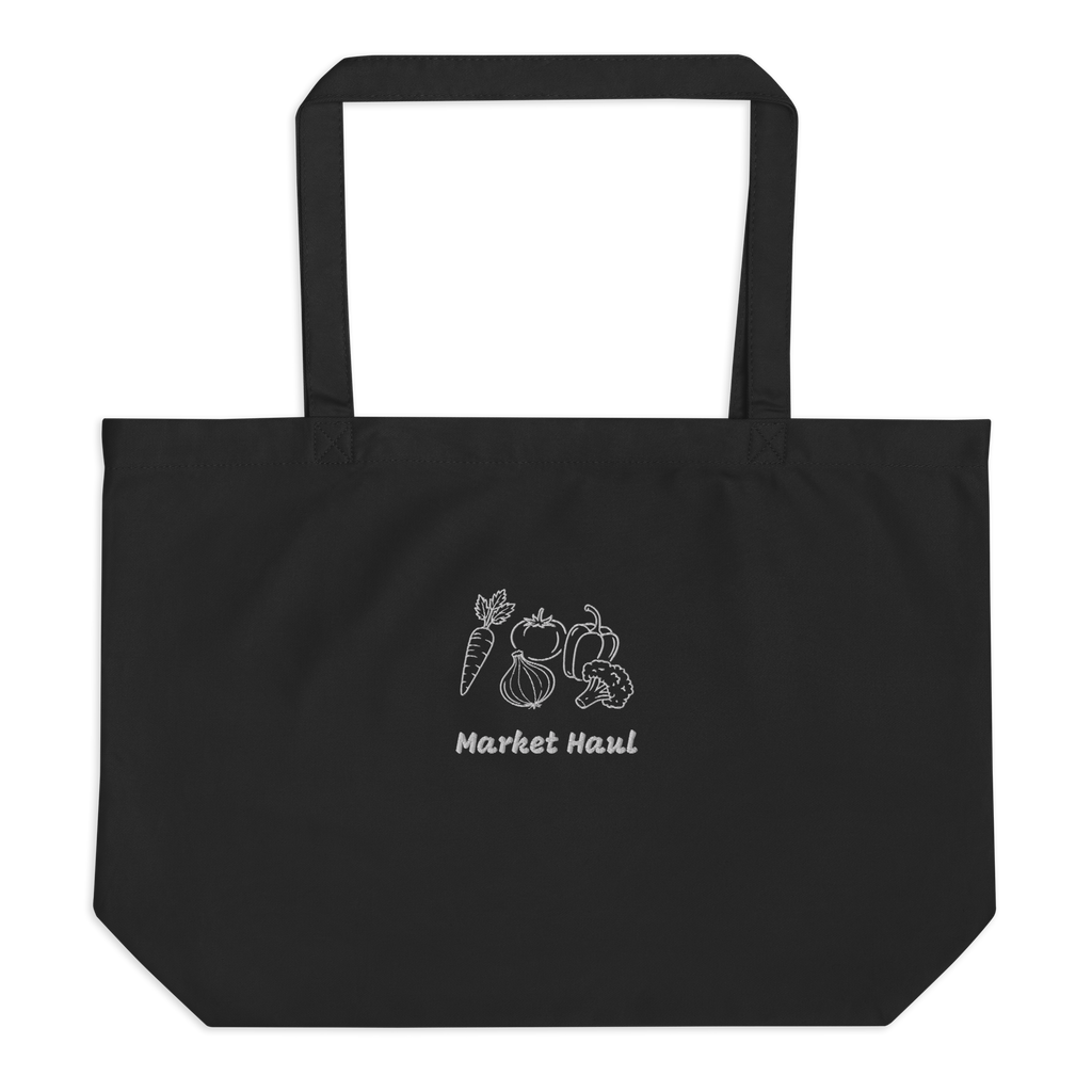 Minimalist "Market Haul" vegetable embroidery including a carrot, tomato, onion, pepper, and broccoli on a natural beige organic cotton tote bag. High-quality stitching detail on 8oz heavyweight fabric.